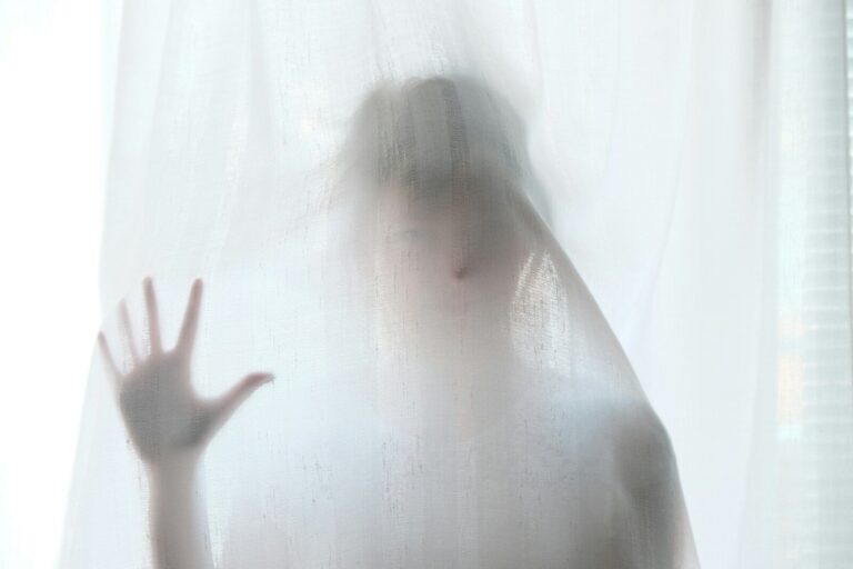Woman Holding Behind Curtain