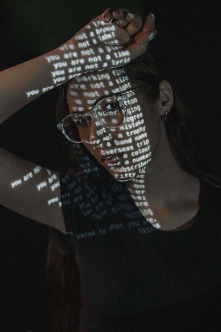 A Woman Wearing Glasses And A T - Shirt With Words Projected On It